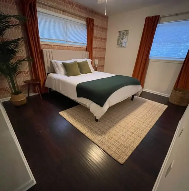 A guest bedroom made up with fresh linens after a turnover