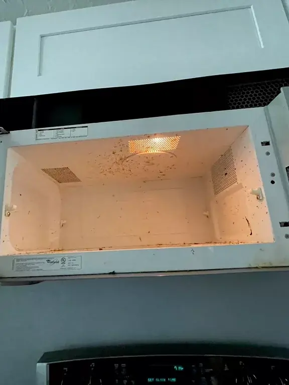 Before: Over-the-range microwave: splattered ceiling and walls, then wiped spotless