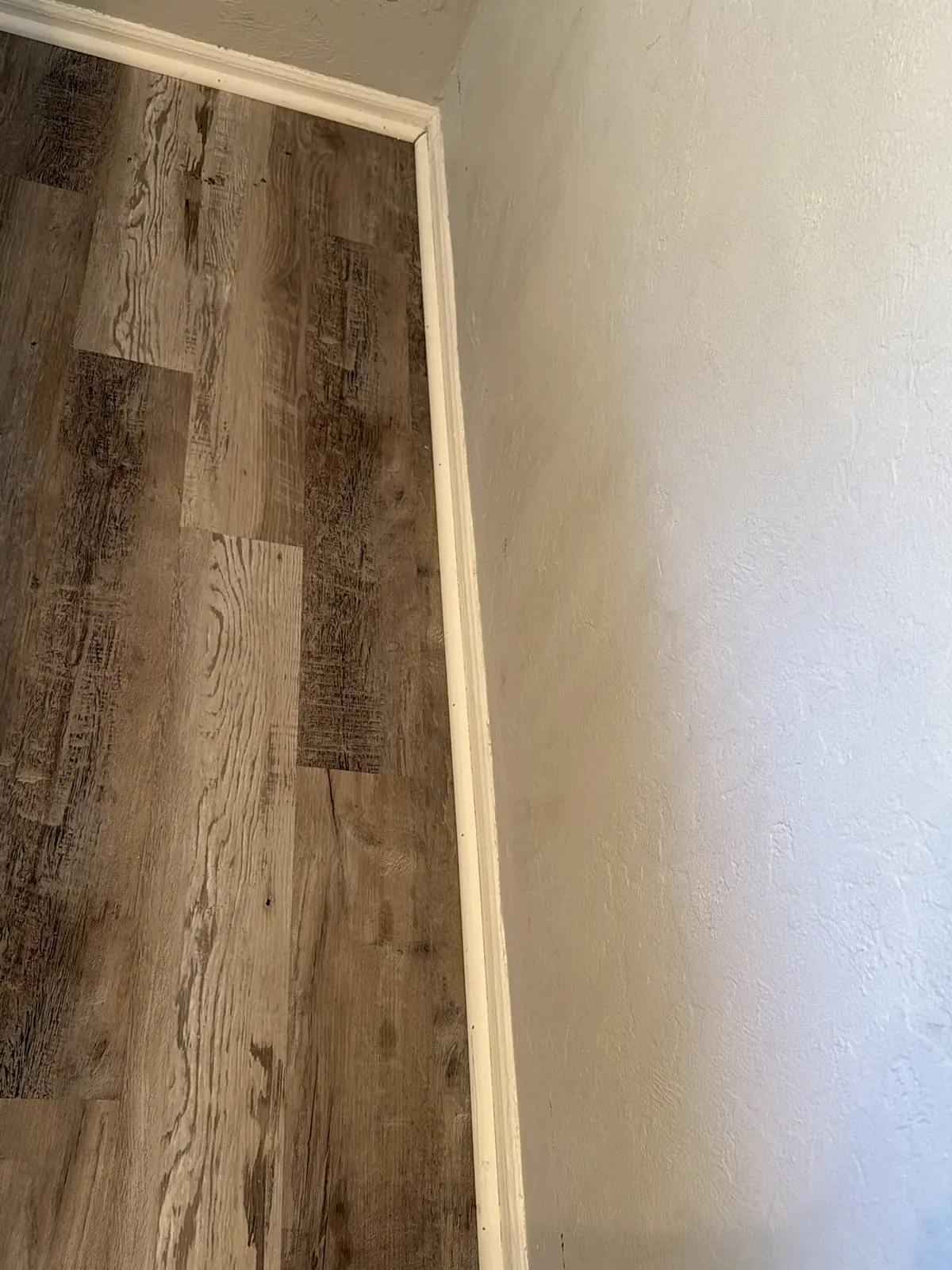 After: A bedroom corner’s wall and baseboard