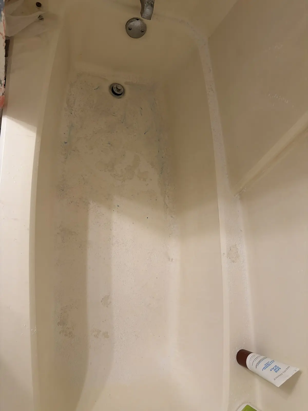 Before: A bathtub’s floor, walls and drain